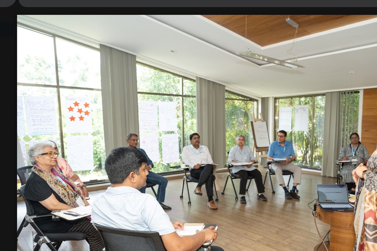 Deep facilitating a circle of leaders in a sunlit room